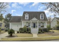 Charming two-story home with a landscaped yard, covered porch, and classic architectural details at 1106 Barfield St, Charleston, SC 29492
