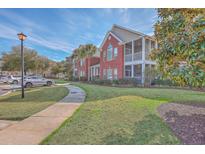 Beautiful two-story building with red brick, a sidewalk and landscaping at 1338 Hopton Cir, Mount Pleasant, SC 29466