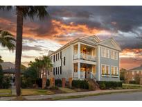 Charming two-story home with a double porch and professionally landscaped front yard with a gorgeous sunset at 146 S Battery St, Charleston, SC 29401