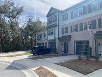 Beautiful townhome with brick and siding, attached garages, and long driveway at 148 Cowrie Ct, Mount Pleasant, SC 29464