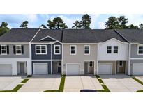 Charming townhome exterior showcasing a well-maintained facade, private garages, and inviting curb appeal at 2204 Scarlett Maple St, Summerville, SC 29486