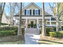Charming home featuring a welcoming front porch, classic shutters, and manicured landscaping at 1992 Pierce St, Charleston, SC 29492