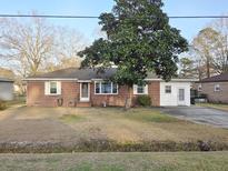 Charming single-story brick home featuring a well-maintained front yard and a comfortable, inviting curb appeal at 228 Jean Wells Dr, Goose Creek, SC 29445