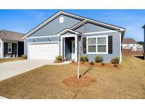 Charming one-story home featuring blue siding, a well-manicured lawn, and an attached garage on a sunny day at 400 Hampstead Ct, Summerville, SC 29486