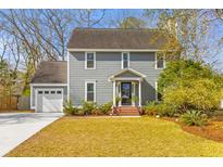 Charming two-story home featuring a well-manicured lawn and an attached two-car garage at 471 Springfield Rd, Mount Pleasant, SC 29464
