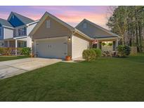 Charming single Gathering home with a two-car garage, cozy front porch, and a beautifully manicured lawn at 5024 Wapiti Way, Hollywood, SC 29449