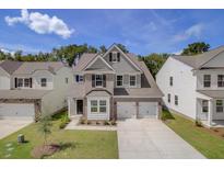 Beautiful two-story home boasts a brick facade, two-car garage, and a well-manicured lawn at 525 Verdi Dr, Summerville, SC 29486