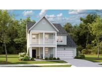 Charming two-story home with a welcoming front porch, attached garage, and lush landscaping at 552 Richfield Way, Summerville, SC 29486