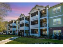 Charming condo building featuring large screened porches and lush landscaping, perfect for enjoying the outdoors at 1025 Riverland Woods Pl # 801, Charleston, SC 29412
