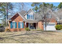 Charming two-story brick home with teal shutters and a well-manicured front yard at 106 Sago Palm Ct, Summerville, SC 29483