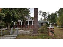 Charming brick home with a small front porch and fenced yard at 107 Grant St, Walterboro, SC 29488