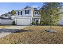 Charming two-story home with blue shutters, a two-car garage, and a well-maintained lawn and landscaping at 1376 Wild Goose Trl, Summerville, SC 29483