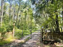 Gated entrance to a wooded property, hinting at privacy and a nature-filled setting at 197 Melrose Pl, Moncks Corner, SC 29461
