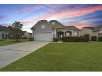 Charming single-Gathering home with a well-manicured lawn, mature tree, and covered front porch at 303 Sand Dune Trl, Summerville, SC 29486