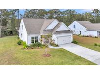 Charming single-Gathering home with a two-car garage, beautiful landscaping, and a well-manicured lawn at 3109 Hugh Bennett Dr, Johns Island, SC 29455