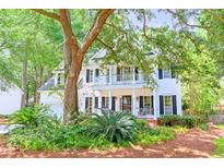 Charming two-story home with a welcoming front porch, balcony and lush landscaping at 405 Springfield Rd, Mount Pleasant, SC 29464