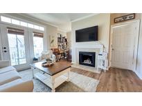 Bright living room featuring a fireplace, modern decor, and access to a patio at 45 Sycamore Ave # 634, Charleston, SC 29407