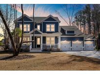 Charming two-story home featuring a welcoming front porch and a spacious three-car garage at 5680 Barbary Coast Rd, Hollywood, SC 29449