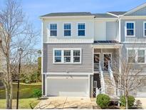 Charming two-story townhome with gray siding, white trim, and a one-car garage at 591 Mclernon Trace, Johns Island, SC 29455