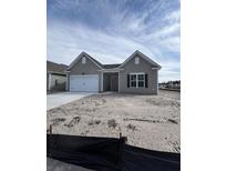 Charming single-story home with a white garage door and a well-lit front window at 631 Marsh Cove Cir, Summerville, SC 29486