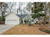 Charming one-story home featuring a manicured lawn and attached two-car garage at 642 Bridlewood Ln, Mount Pleasant, SC 29466