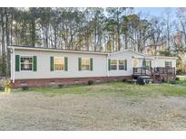 Charming single-story home with green shutters, a brick foundation, and a cozy front porch at 754 Miriam Ln, Ridgeville, SC 29472