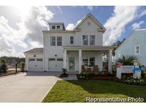 Charming two-story home with a welcoming front porch and attached two-car garage in a Gathering-friendly neighborhood at 1054 Marsh Harrier Dr # Cc3-15-5P, Ravenel, SC 29470