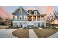 Charming two-story home featuring a spacious front porch and beautifully landscaped front yard at 1189 Pinefield Dr, Charleston, SC 29492