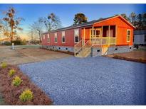 Charming single-story home with a welcoming front porch and freshly graveled front yard at 122 Liferidge Ct, Moncks Corner, SC 29461