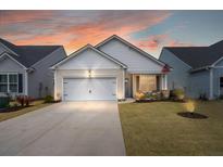 Charming single-Gathering home featuring a two-car garage, inviting front porch, and well-maintained landscaping at 125 Leeward Landing, Summerville, SC 29486