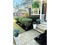 Charming brick home with a beautifully landscaped front entrance and walkway at 2601 Mona Ave, Charleston, SC 29414