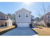 Charming two-story home with a two-car garage, landscaped yard, and inviting curb appeal at 317 Cantley Ct, Summerville, SC 29486