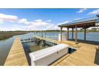 Private wooden dock features a covered gazebo, boat lift and easy access to the waterway at 3398 Freeman Hill Rd, Johns Island, SC 29455