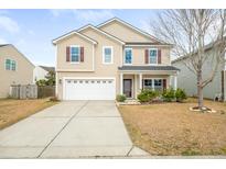 Charming two-story home with a well-maintained front yard and attached two-car garage at 406 Butterfly Bush Dr, Goose Creek, SC 29445