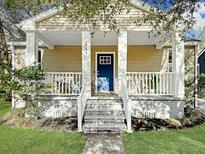 Charming home with a blue front door, white porch railings, and a cozy, inviting entrance at 4754 Aster Dr, North Charleston, SC 29405