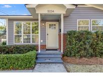 Charming home entrance with a gray exterior, well-maintained landscaping, and a welcoming front door at 5034 Pittman St, North Charleston, SC 29405