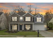 Charming two-story home with a well-manicured lawn and attached two-car garage at 518 Mountain Laurel Cir, Goose Creek, SC 29445