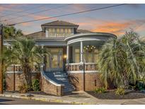 Stunning brick house with a grand entrance and a picturesque, turret-style covered porch perfect for relaxation at 54 Gibbes St, Charleston, SC 29401