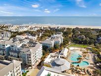 Beautiful aerial view of oceanfront resort community with pools, beach access, and well-maintained grounds at 5802 Palmetto Dr # B-202, Isle of Palms, SC 29451