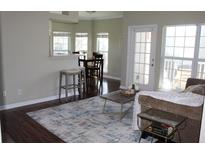 Cozy living room features wood floors, bright windows, and a comfortable seating area perfect for relaxing at 700 Daniel Ellis Dr # 6107, Charleston, SC 29412