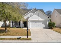 Charming home featuring a white facade, well-maintained lawn, and attached two-car garage at 109 Arbor Oaks Dr, Summerville, SC 29485