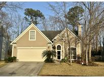 Charming single-Gathering home with a well-manicured lawn, attached garage, and traditional architectural details at 130 E Hartwick Ln, Goose Creek, SC 29445