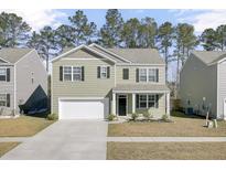 Charming two-story home with a well-manicured lawn, a two-car garage, and a welcoming front porch at 146 Summit View Dr, Summerville, SC 29486