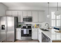 Bright kitchen features stainless steel appliances and white cabinetry at 2021 Arbutus Ave, North Charleston, SC 29405