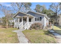 Charming single-story home with a cozy front porch and well-maintained landscaping at 2969 Bobo Rd, Mount Pleasant, SC 29466