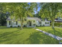 Charming single-story home with a well-maintained lawn and mature trees at 318 Hollywood Dr, Charleston, SC 29407