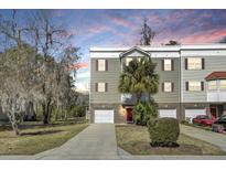 A charming multi-story townhome with a driveway and lush landscaping at 4610 Palm View Cir, North Charleston, SC 29418