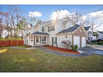 Charming two-story home with a well-maintained lawn, a two-car garage, and a welcoming front porch at 5429 Roxbury Dr, North Charleston, SC 29418