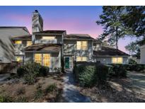 Charming two-story home with lush landscaping and inviting walkway to the front door at 1042 Planters Pl, Mount Pleasant, SC 29464