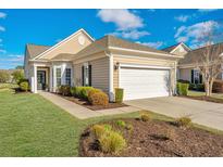 Charming single-story home with manicured lawn, attached garage, and inviting entrance at 106 Sea Lavender Ln, Summerville, SC 29486